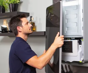 Man Removing Panel from Boiler