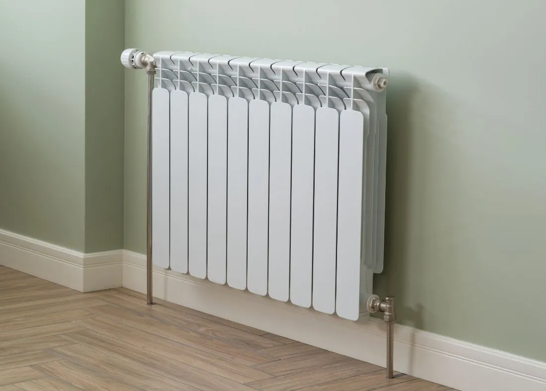 A radiator on a green wall